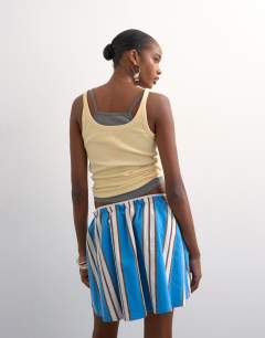 Model wearing Elasticated mini skirt in sporty blue stripe