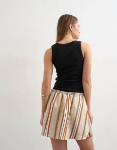 Model wearing Elasticated mini skirt in sporty rust stripe