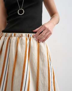 Model wearing Elasticated mini skirt in sporty rust stripe