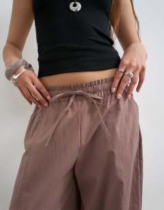 Model wearing Elasticated waist cuffed hem techy trouser in brown