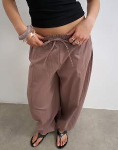 Model wearing Elasticated waist cuffed hem techy trouser in brown
