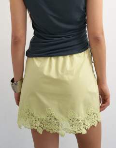 Model wearing Elasticated waist lace petticoat mini skirt in chartreuse
