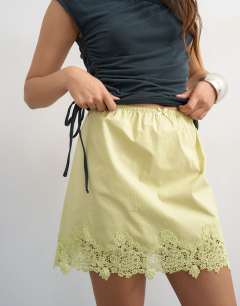 Model wearing Elasticated waist lace petticoat mini skirt in chartreuse
