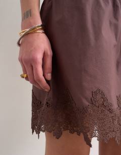 Model wearing Elasticated waist lace petticoat mini skirt in chocolate