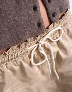 Model wearing Elasticated waist mini skort in beige