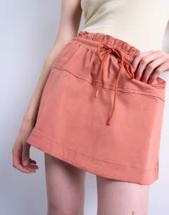 Model wearing Elasticated waist mini skort in rust