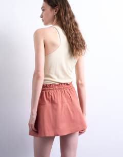 Model wearing Elasticated waist mini skort in rust