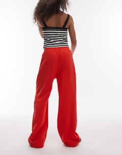 Model wearing Elasticated waistband tailored jogger trouser in red