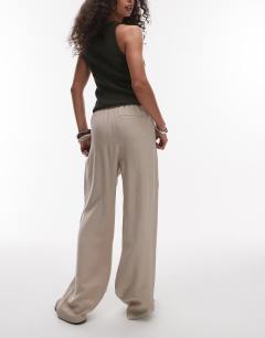 Model wearing Elasticated waistband tailored jogger trouser in stone