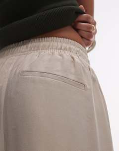 Model wearing Elasticated waistband tailored jogger trouser in stone