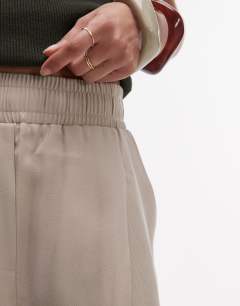 Model wearing Elasticated waistband tailored jogger trouser in stone