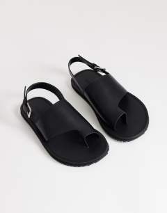 Model wearing Ella leather toe loop sandal in black