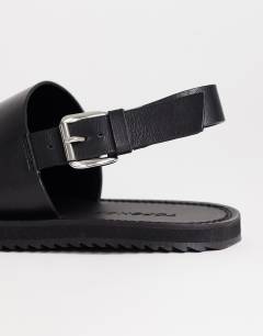 Model wearing Ella leather toe loop sandal in black