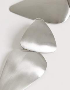Model wearing Elliot statement stud earring in silver brushed