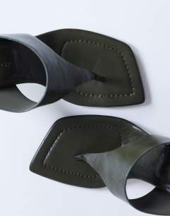 Model wearing Elodie toe thong heeled mule in khaki