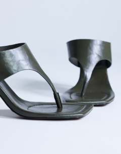 Model wearing Elodie toe thong heeled mule in khaki