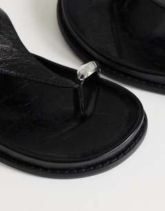 Model wearing Elsie hardware footbed sandal in black