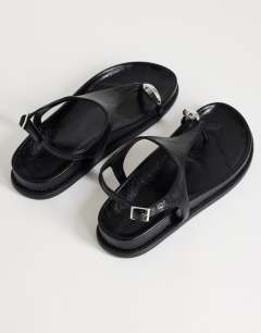 Model wearing Elsie hardware footbed sandal in black