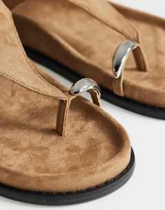 Model wearing Elsie hardware footbed sandal in taupe faux suede 