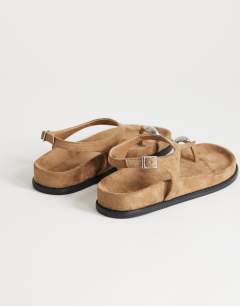 Model wearing Elsie hardware footbed sandal in taupe faux suede 