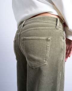 Model wearing Ember low rise cord jean in sage