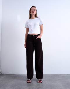 Model wearing Ember low rise cord straight leg jeans in bitter chocolate