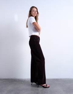 Model wearing Ember low rise cord straight leg jeans in bitter chocolate