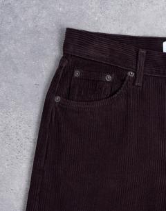 Model wearing Ember low rise cord straight leg jeans in bitter chocolate