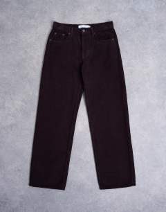 Model wearing Ember low rise cord straight leg jeans in bitter chocolate