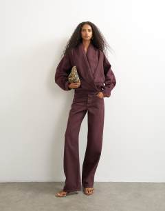 Model wearing Ember low rise relaxed straight jean in aubergine