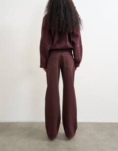 Model wearing Ember low rise relaxed straight jean in aubergine