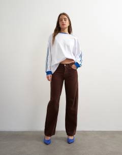 Model wearing Ember low rise relaxed straight jean in chocolate cord