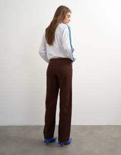 Model wearing Ember low rise relaxed straight jean in chocolate cord