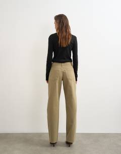 Model wearing Ember low rise relaxed straight jean in sand