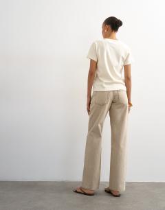 Model wearing Ember low rise relaxed straight leg jean in beige