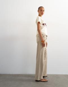 Model wearing Ember low rise relaxed straight leg jean in beige
