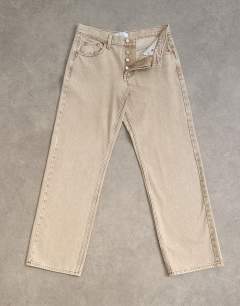 Model wearing Ember low rise relaxed straight leg jean in beige