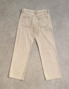 Model wearing Ember low rise relaxed straight leg jean in beige
