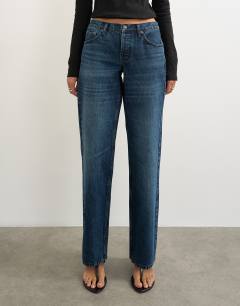 Model wearing Ember low rise relaxed straight leg jean in blue black