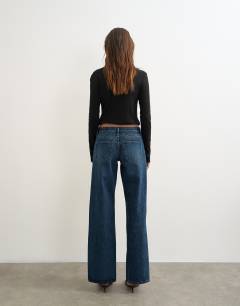 Model wearing Ember low rise relaxed straight leg jean in blue black