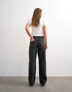 Model wearing Ember low rise relaxed straight leg jean in washed black - BLACK