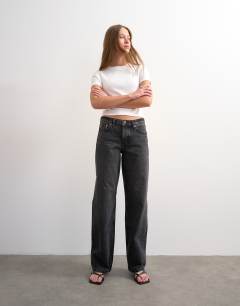 Model wearing Ember low rise relaxed straight leg jean in washed black - BLACK
