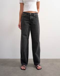 Model wearing Ember low rise relaxed straight leg jean in washed black