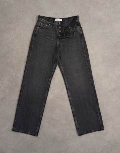 Model wearing Ember low rise relaxed straight leg jean in washed black