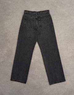 Model wearing Ember low rise relaxed straight leg jean in washed black