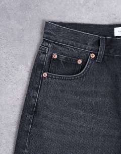 Model wearing Ember low rise relaxed straight leg jean in washed black