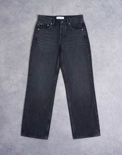 Model wearing Ember low rise relaxed straight leg jean in washed black