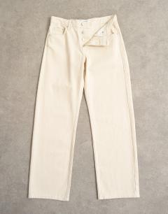 Model wearing Ember low rise relaxed straight leg jean with lace up detail in oat