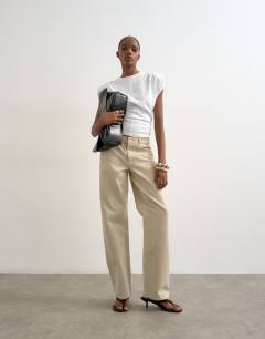 Model wearing Ember low rise straight jean in oat