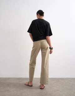 Model wearing Ember low rise straight leg jean in beige